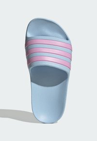 Light blue slide sandal with a textured surface and four pink horizontal stripes across the upper. Open-toe design, flat sole.