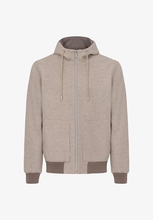 Beige zip-up hoodie made of soft fabric, featuring a hood, two front pockets, ribbed cuffs, and a smooth zipper with textured accents.