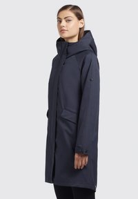 Navy waterproof coat with a hood, featuring a straight cut, side pockets, and buttoned cuffs, made from smooth, textured fabric.