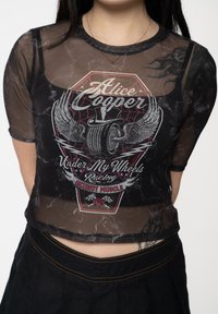Black mesh cropped top featuring a graphic print of "Alice Cooper" with wings, tire, and text "Under My Wheels Racing." Short sleeves, textured fabric.