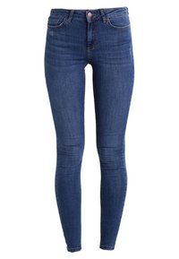 Kapeat siniset farkut, valmistettu denimistä. Korkeavyötäröiset klassisella viiden taskun muotoilulla, ja reisissä on hienovaraista kulumista. Stretch-kangas mukavuutta varten.