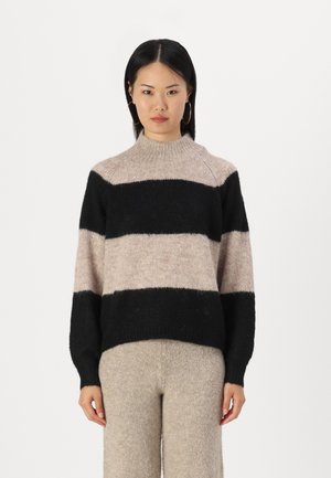 Knit sweater with black and beige horizontal stripes, ribbed high neck, and long sleeves. Soft texture, relaxed fit, and simple design.