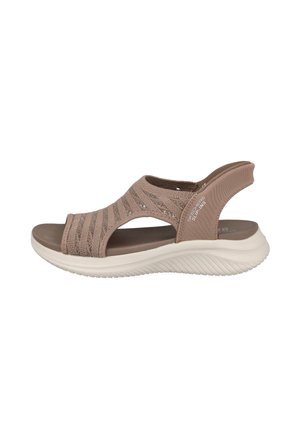 Sandalia taupe sin cordones con parte superior de punto, suela blanca acolchada y tira abierta en el talón, diseñada para comodidad y soporte casual.