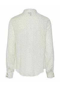 White long-sleeve blouse with a subtle floral pattern and vertical stripes, featuring buttoned cuffs and a relaxed fit design.