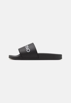 Black slide sandal with a wide strap featuring the logo, made of synthetic material, flat sole, smooth texture, and minimalist design.