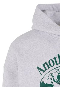 Gray hoodie made of soft fabric, featuring a front graphic in dark green with text and a circular design. Includes a drawstring hood.