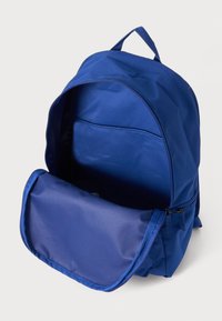 Blue fabric backpack with a wide opening, zipper closure, and an inner pocket; smooth texture with reinforced stitching and a top handle.