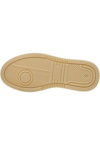 Semelle de chaussure en caoutchouc de couleur beige clair, présentant un motif en zigzag, un bord arrondi et des rainures de traction prononcées. Comprend un creux circulaire et un détail de marque.