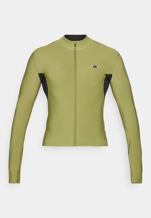 Long-sleeve zip-up jacket in olive green and black, featuring a high collar and a logo on the chest, made from a smooth, stretchy fabric.