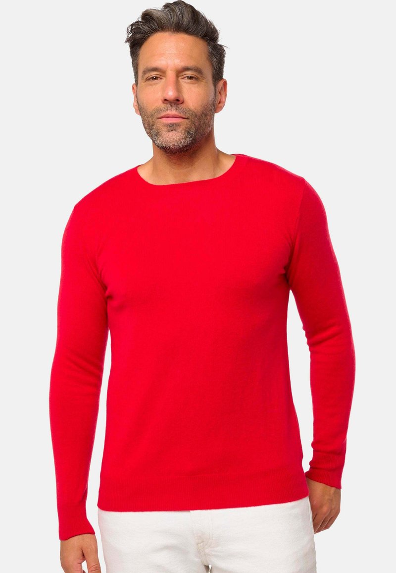Pull-over rouge à manches longues en mailles lisses, avec un col rond et des poignets et un ourlet côtelés. Design simple et uni.