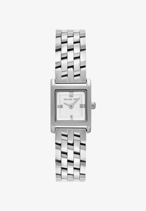 Neliön muotoinen hopeansävyinen kello, jossa on teksturoitu valkoinen kellotaulu, hoikat tuntimarkerit ja ruostumattomasta teräksestä valmistettu linkkiranneke. Minimalistinen muotoilu.