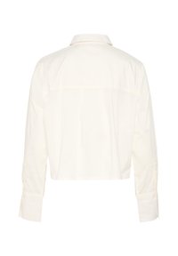 Cropped white shirt with long sleeves, buttoned cuffs, collar, and a smooth, plain texture. Features a back yoke seam and no visible closures.