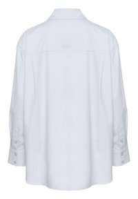 White, long-sleeve shirt with a button-down collar. Features a back yoke and a subtle embroidered logo. Soft, smooth fabric texture.