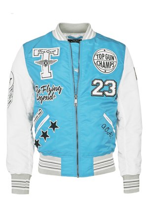 Sininen pommikaukkupaita valkoisilla hihoilla, brodeerattuja merkkejä ja mustia yksityiskohtia. Sisältää ribbikudin hihnat ja helman, vetoketjusuljenta ja graafista tekstiä.