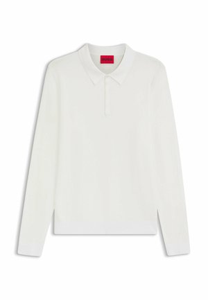 White long-sleeve polo shirt with a soft texture, buttoned collar, and ribbed cuffs. Features a branded red label inside the neckline.