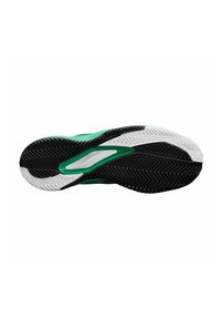 Semelle en caoutchouc noir avec un motif en chevrons texturé, dotée d'accents verts et blancs, conçue pour l'adhérence et la stabilité.