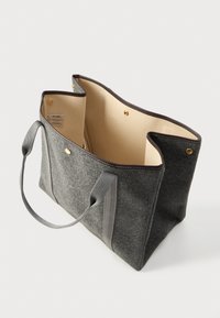 Γκρι τσάντα tote από τσόχα με καφέ λεπτομέρειες, διπλές λαβές, κλείσιμο με κουμπί και εσωτερική επένδυση σε μπεζ απόχρωση, σε λευκό φόντο.