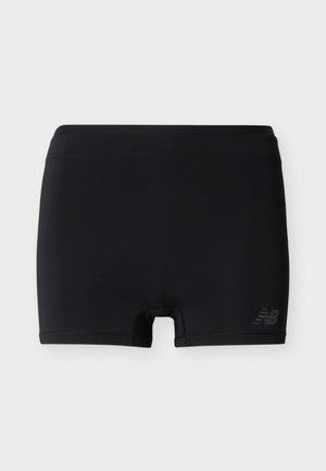 Schwarze athletische Kompressionsshorts mit einem enganliegenden Bund und einem kleinen reflektierenden New Balance-Logo am unteren rechten Bein.