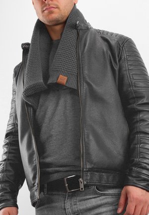 Black leather jacket with textured shoulders, paired with a gray knitted scarf and gray t-shirt, set against a white background.