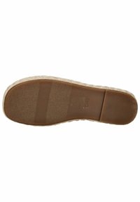 Tan espadrille sko sål med tekstureret gummi bund, der har vandrette riller og en let hæl. Brandlogoet er synligt.