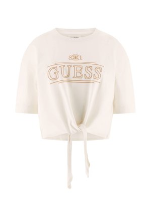 White, cropped t-shirt made of soft cotton with short sleeves, featuring a gold "GUESS" logo and a front knot detail at the hem.