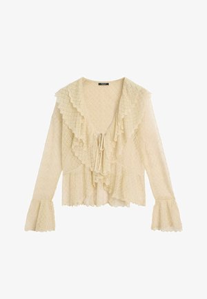 Cremefarbene Spitzenbluse mit langen Ärmeln, tiefem V-förmigem Rüschenkragen, vorne zum Binden und ausgestellten Manschetten mit zartem, strukturiertem Muster.