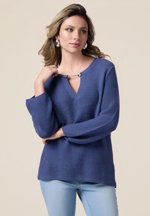 Pull en maille bleu avec un col en V, présentant un accent métallique au niveau du col et des manches longues amples. Texture douce.