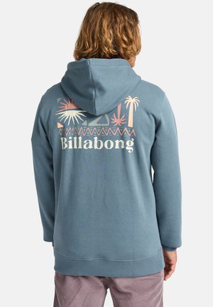 Blue hoodie made of cotton, featuring a large graphic print with palm trees and "Billabong" text on the back. Soft, textured finish.