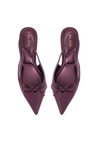 Lila keinonnahasta valmistetut slingback-tasapohjat, joissa on teräväkärkinen muotoilu, koristeellinen nauha jokaisessa kengässä sekä leikattu muotoilu sivuilla. Brändin nimi sisällä.