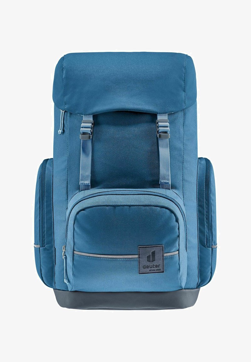 Sac à dos bleu au design structuré, doté de bretelles réglables, d'une poche zippée à l'avant et d'un écusson logo en bas à droite.