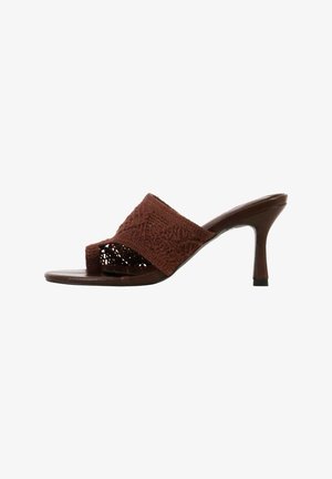 Mule sandale marron à bout ouvert avec une lanière large texturée, une boucle pour les orteils et un talon stiletto de hauteur moyenne sur fond blanc.