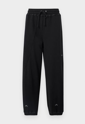 Pantaloni felpa neri con vita regolabile, design a gamba stretta e dettaglio logo sottile vicino all'orlo. Realizzati in un tessuto morbido e liscio.