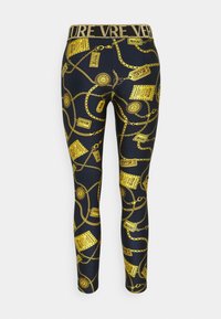 Marinblå leggings med ett mönster av guldkedjor och etiketter. Elastiskt midjeband med texten "FOREVER" i glitter. Slät, stretchig tyg.