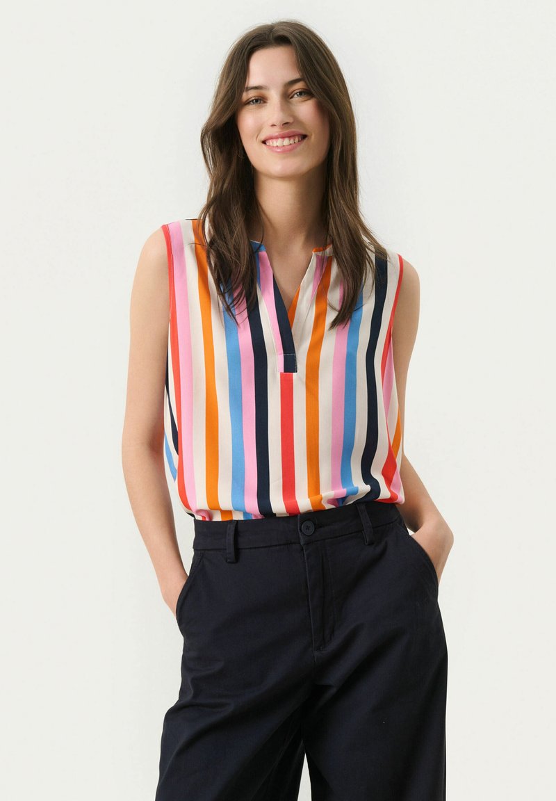 Sleeveless blouse in colorful vertical stripes, featuring a v-neckline and smooth fabric. Paired with navy trousers, showcasing a relaxed fit.