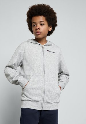 Sweatshirt cinza com fecho, bolso frontal tipo canguru, punhos e bainha canelados. Apresenta um pequeno logotipo da Champion no peito esquerdo.