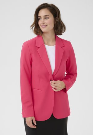 Pink tailored blazer made of smooth fabric, featuring a notched lapel, single button closure, and front pockets. Worn over a white top.