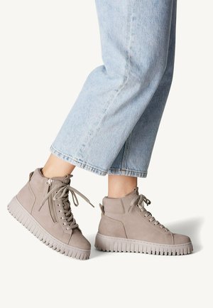 Gray high-top sneakers made of suede with a textured rubber sole, lace-up front, and a side zipper for easy wear.