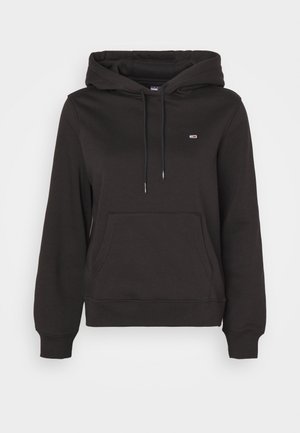 Black hoodie with a front pocket, drawstring hood, and ribbed cuffs. Features a small logo on the chest. Made of soft fabric.