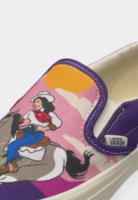 Καουμπόισσα που καβαλάει άλογο μπροστά σε ροζ ουρανό με σύννεφα και πορτοκαλί ήλιο, αποτυπωμένη σε μοβ παπούτσι Vans slip-on.