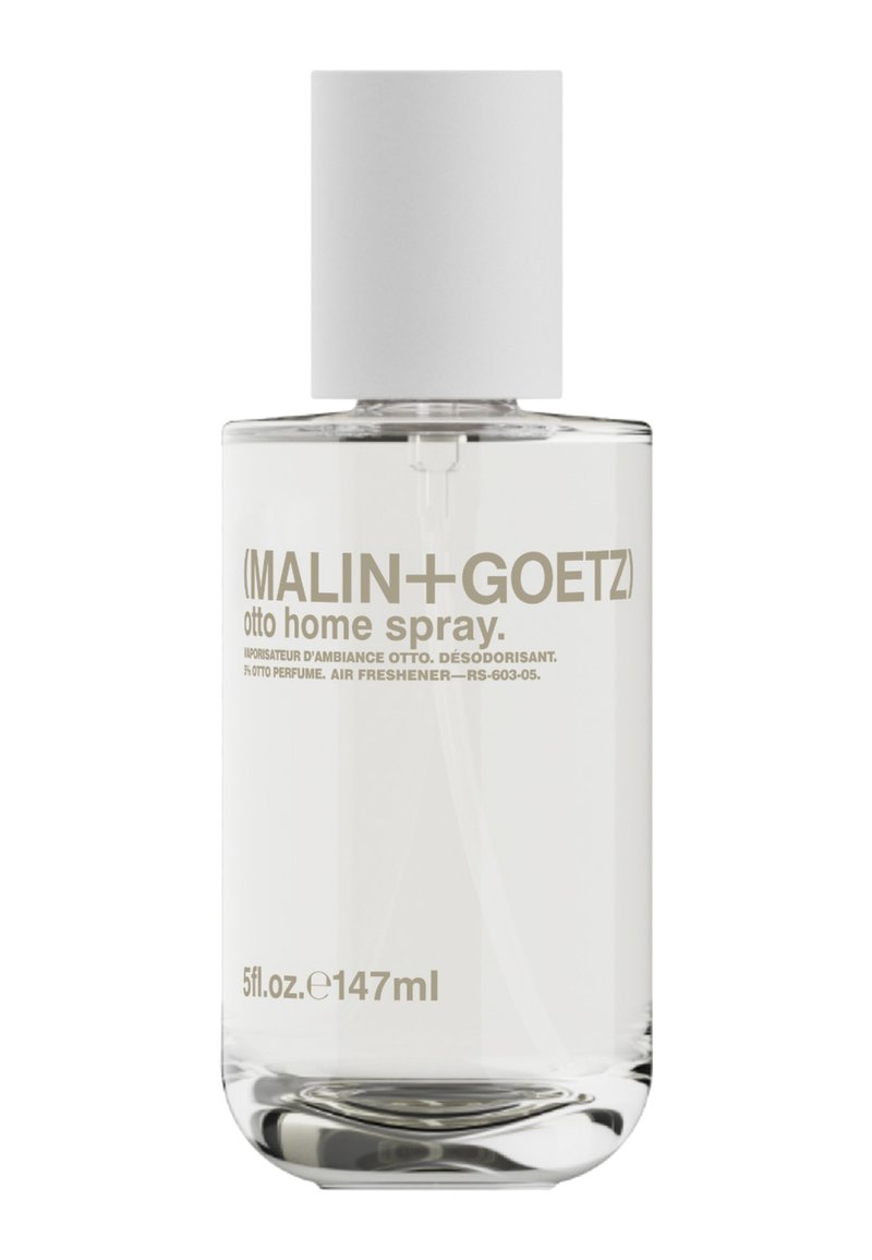 Klarer Glasflasche mit Haarspray und weißem Deckel. Das Etikett enthält hellgraue Schrift, die den Produktnamen und das Volumen angibt. Einfaches zylindrisches Design.