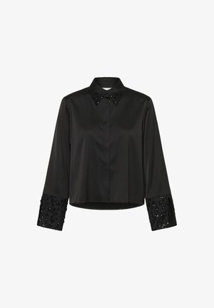 Camicia nera a maniche lunghe con colletto su misura. Presenta dettagli decorati con paillettes sui polsini, design aderente e una texture di tessuto liscia.