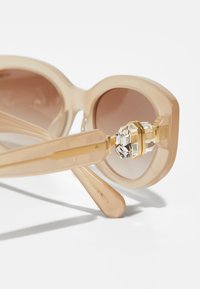 Swarovski Solbriller - beige/brown