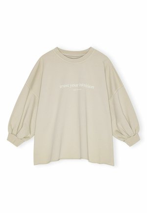 Maglione beige con maniche lunghe a sbuffo. Presenta un collo rotondo e la scritta stampata "fidati del tuo intuito" sul davanti. Tessuto morbido.