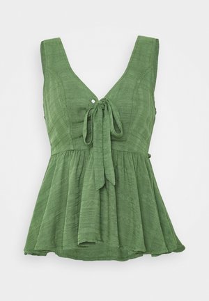 Grüne ärmellose Bluse mit Struktur, V-Ausschnitt, vorderer Knotenverschluss und ausgestellter, geraffter Taille.