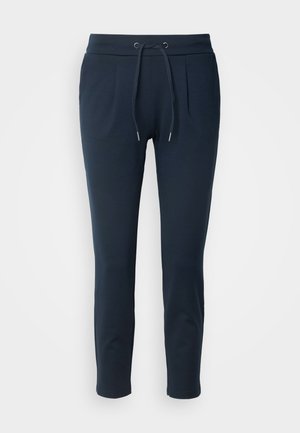 Pantalon de jogging bleu marine en tissu doux, doté d'une ceinture élastique avec cordon de serrage, de deux poches latérales et d'une coupe slim.