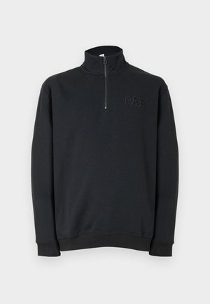 Must ükspisarmeline pikkade varrukatega veerandlukuga dressipluus kõrge kraega ja vasakul rinnal reljeefse "GAP" logoga.