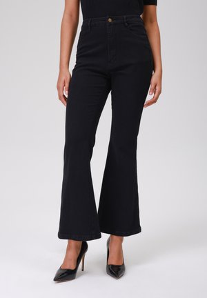 Black flared jeans with a high waist, made of denim. Features front pockets and a metal button at the waist. Textured fabric.