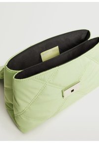 Light green quilted bag with a smooth texture, featuring a silver metal clasp and a black fabric interior. Includes an MNG tag inside.