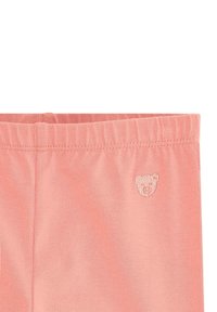 Leggings di cotone rosa con una vita elasticizzata e un piccolo logo di un orsetto ricamato sul davanti, caratterizzati da una texture liscia e un design aderente.