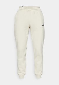 Cremefarvede sweatpants lavet af blødt bomuldsblanding. Har elastisk talje og manchetter, med et lille sort Puma-logo på venstre lår.